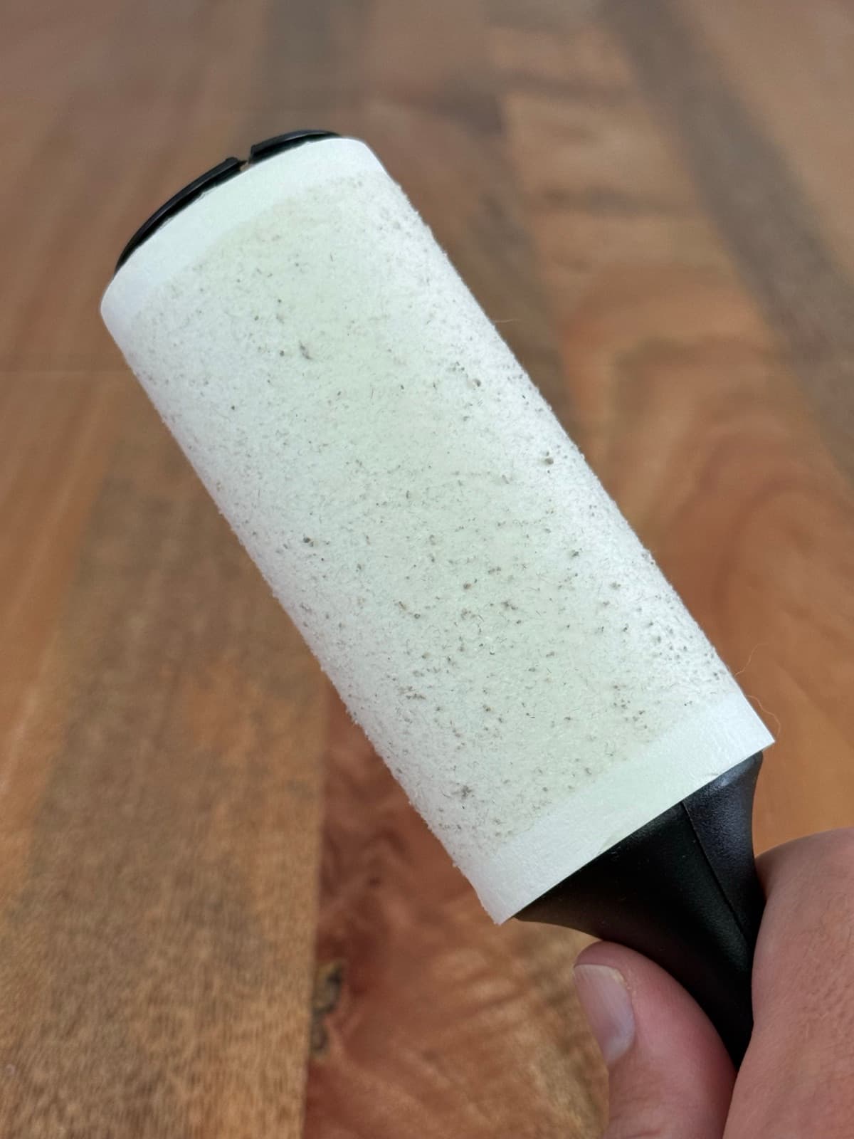 A lint roller covered in loose pills picked up after a pass with the Couch Shaver.